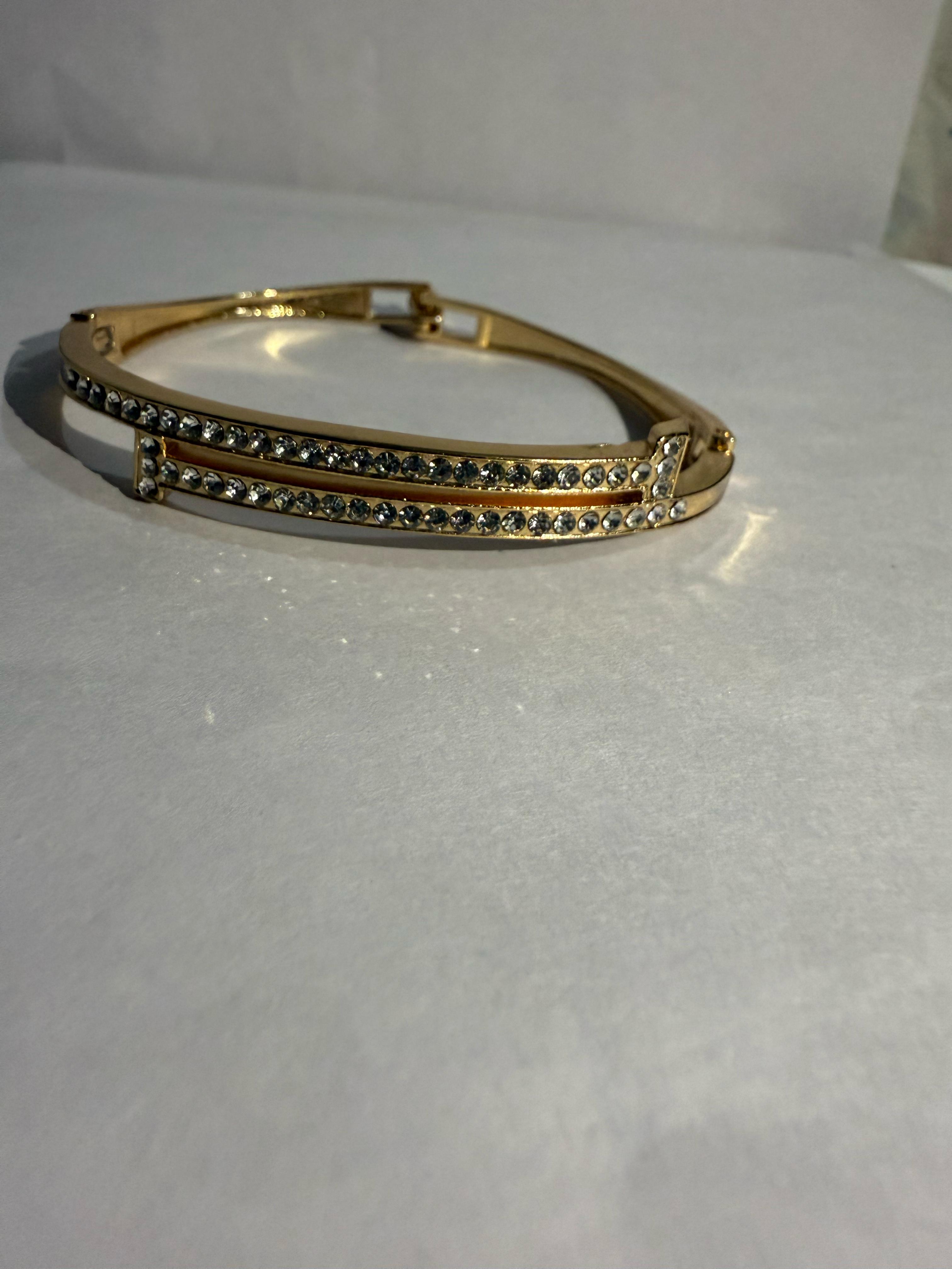 Stunning Gold-Toned Artificial Cuff Bracelet with Sparkling Rhinestones.
