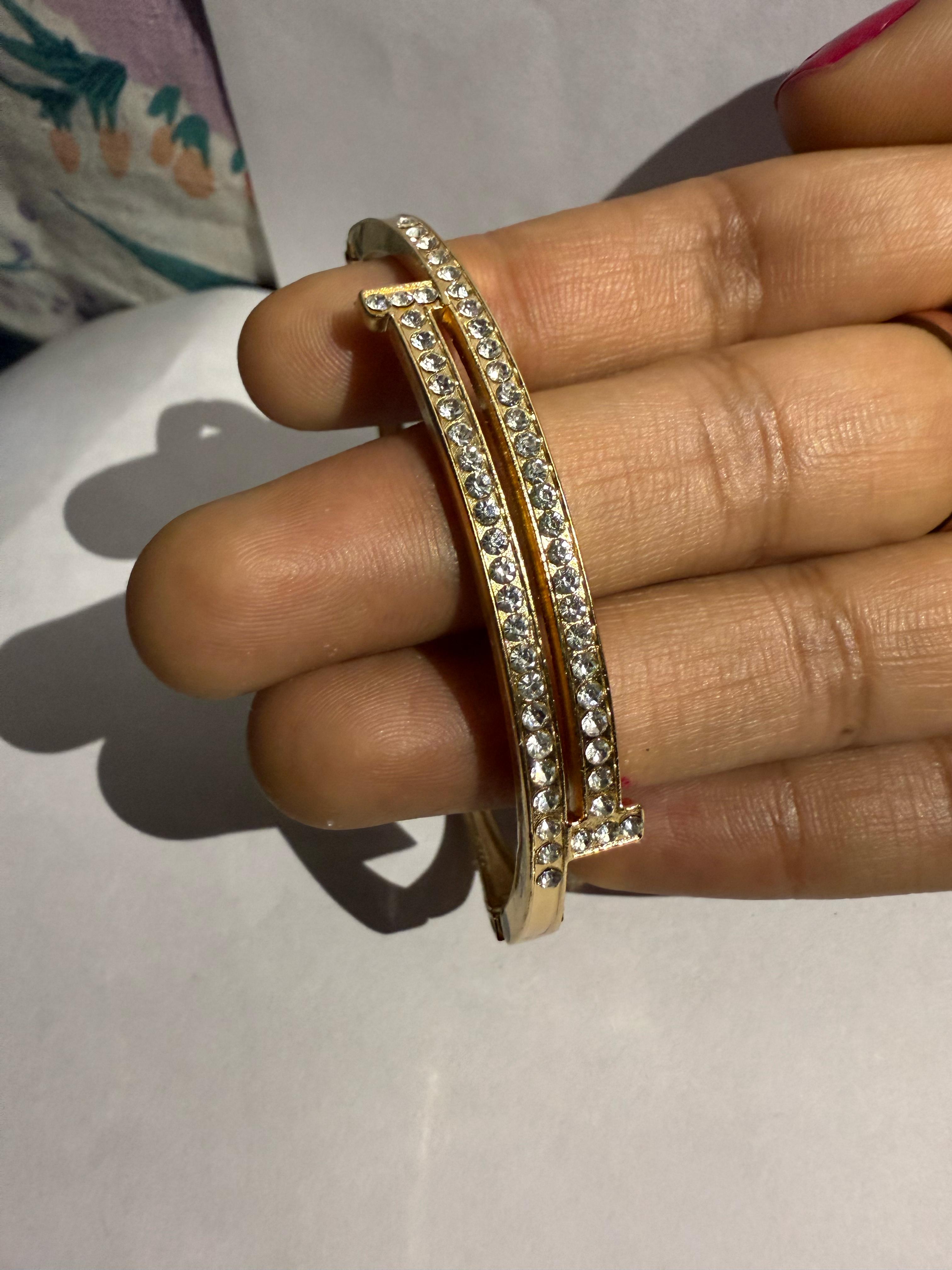 Stunning Gold-Toned Artificial Cuff Bracelet with Sparkling Rhinestones.